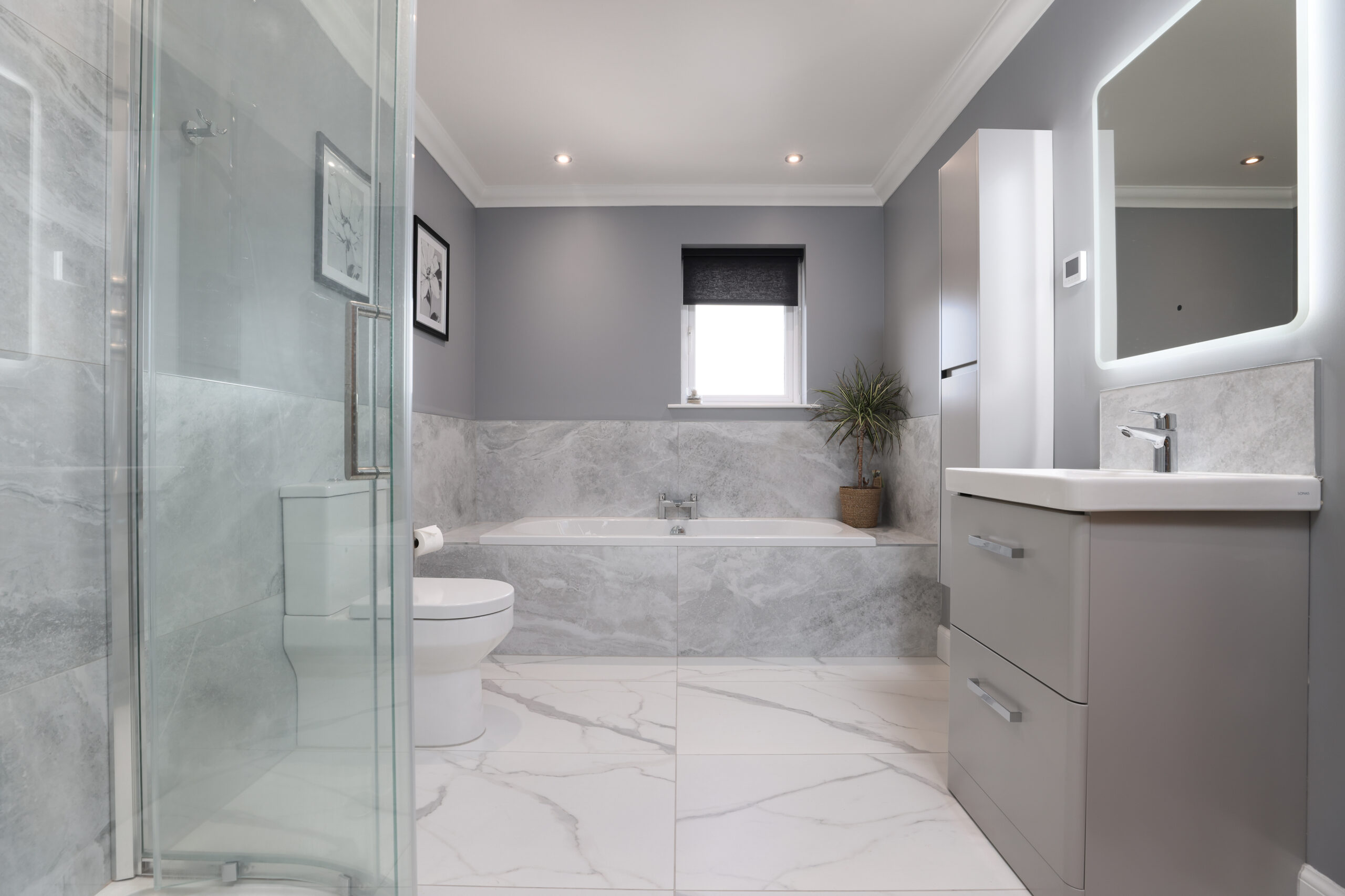 A modern bathroom renovation in Blairgowrie featuring a well-appointed shower area, a bath, and a contemporary vanity unit.
